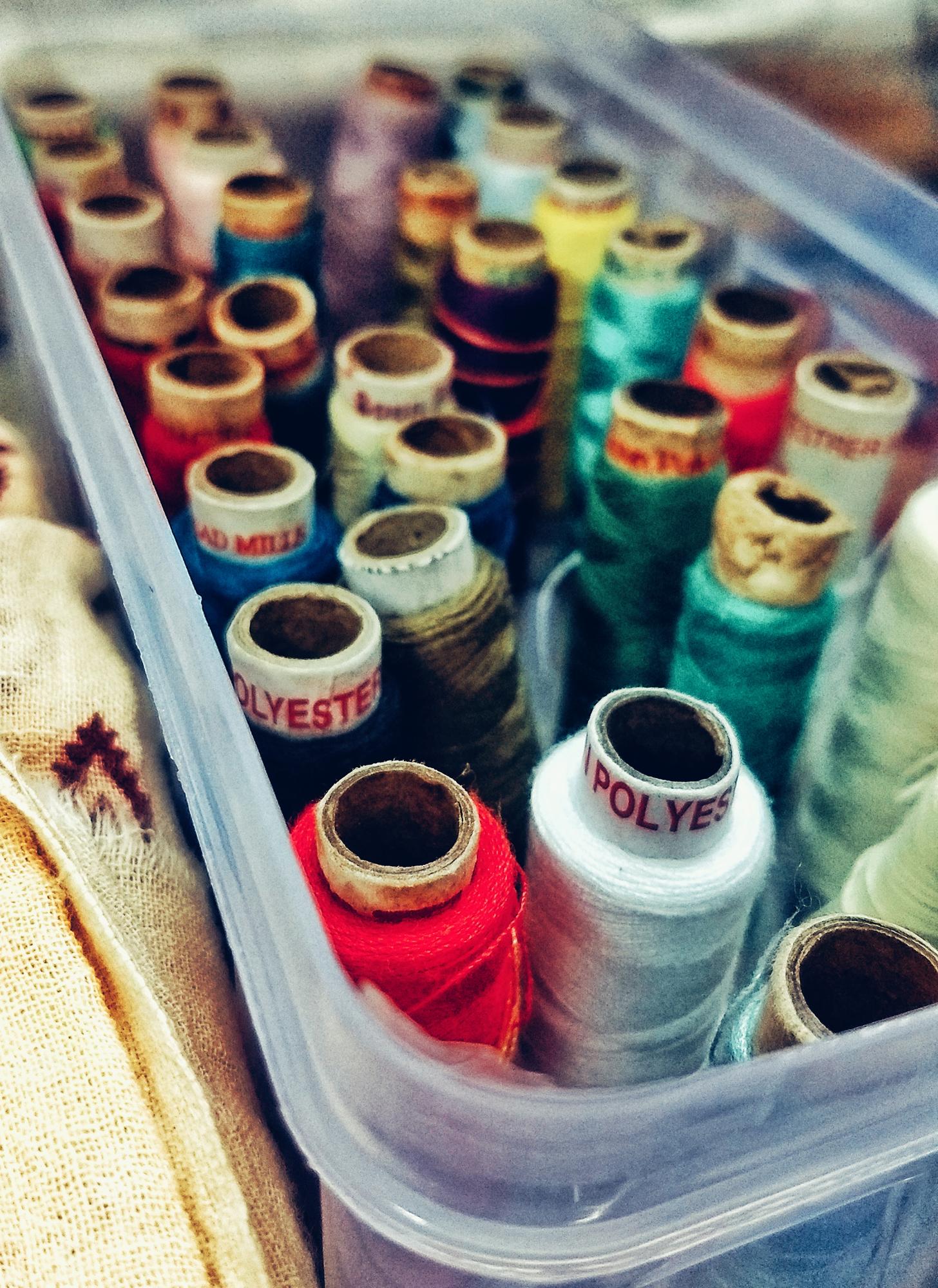 Studio workspace with embroidery machines and samples